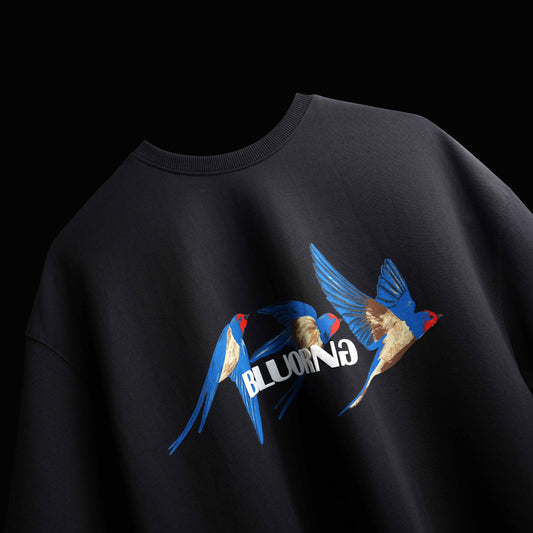 Premium oversized black t-shirt with dynamic bird-in-motion graphic