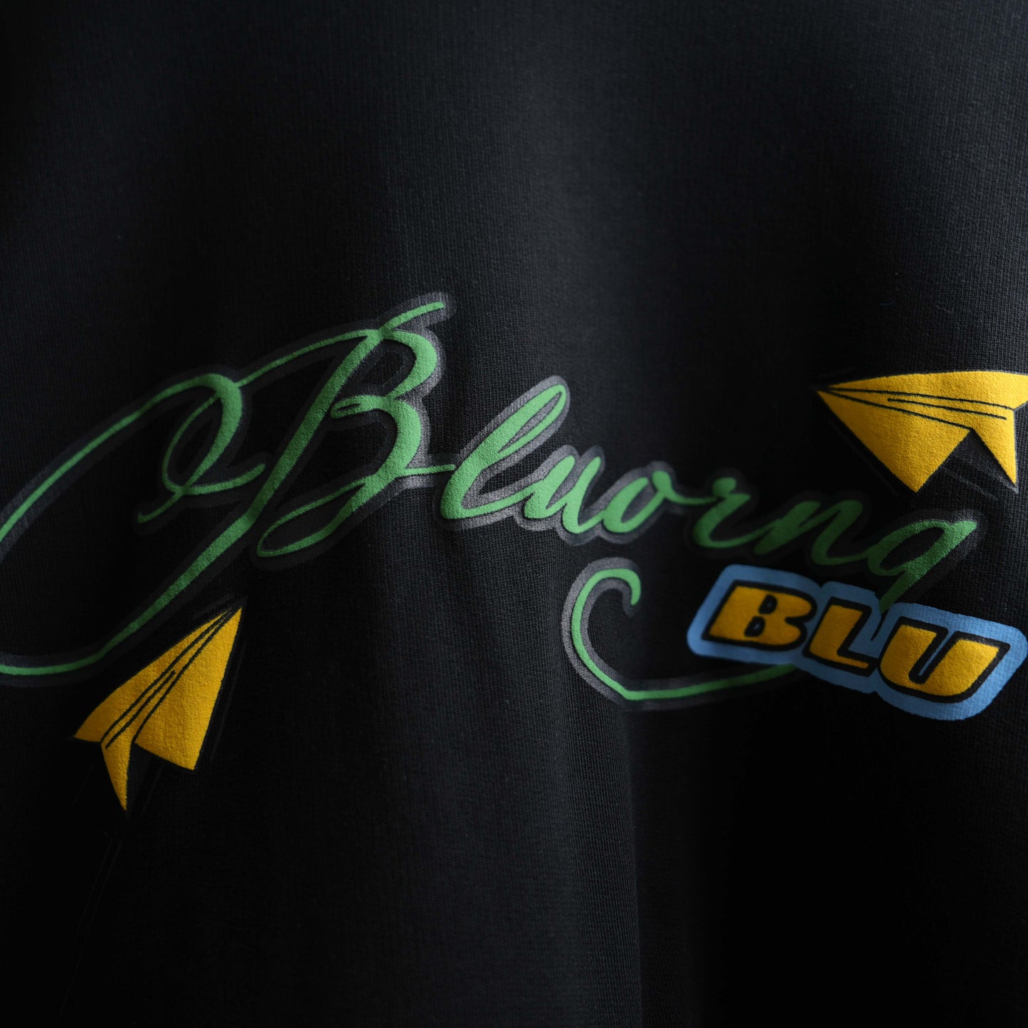 Black oversized t-shirt featuring raised sticker slap graphics