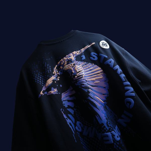 Premium oversized navy blue t-shirt with dynamic bird-in-motion graphic