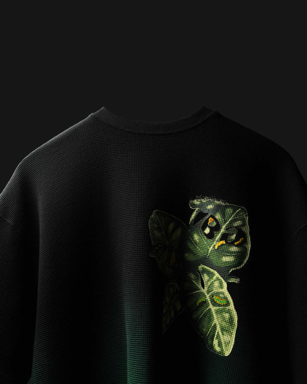 Black Fade Flora with green caterpillar design on a dark background