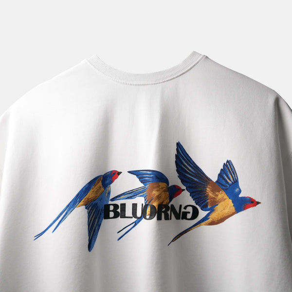 Premium oversized white t-shirt with dynamic bird-in-motion graphic