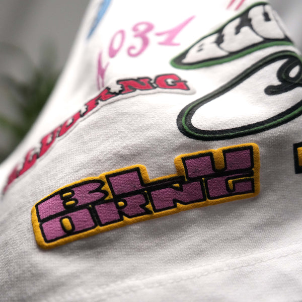 White oversized t-shirt featuring raised sticker slap graphics