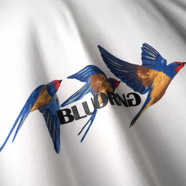White oversized statement t-shirt with dynamic bird artwork
