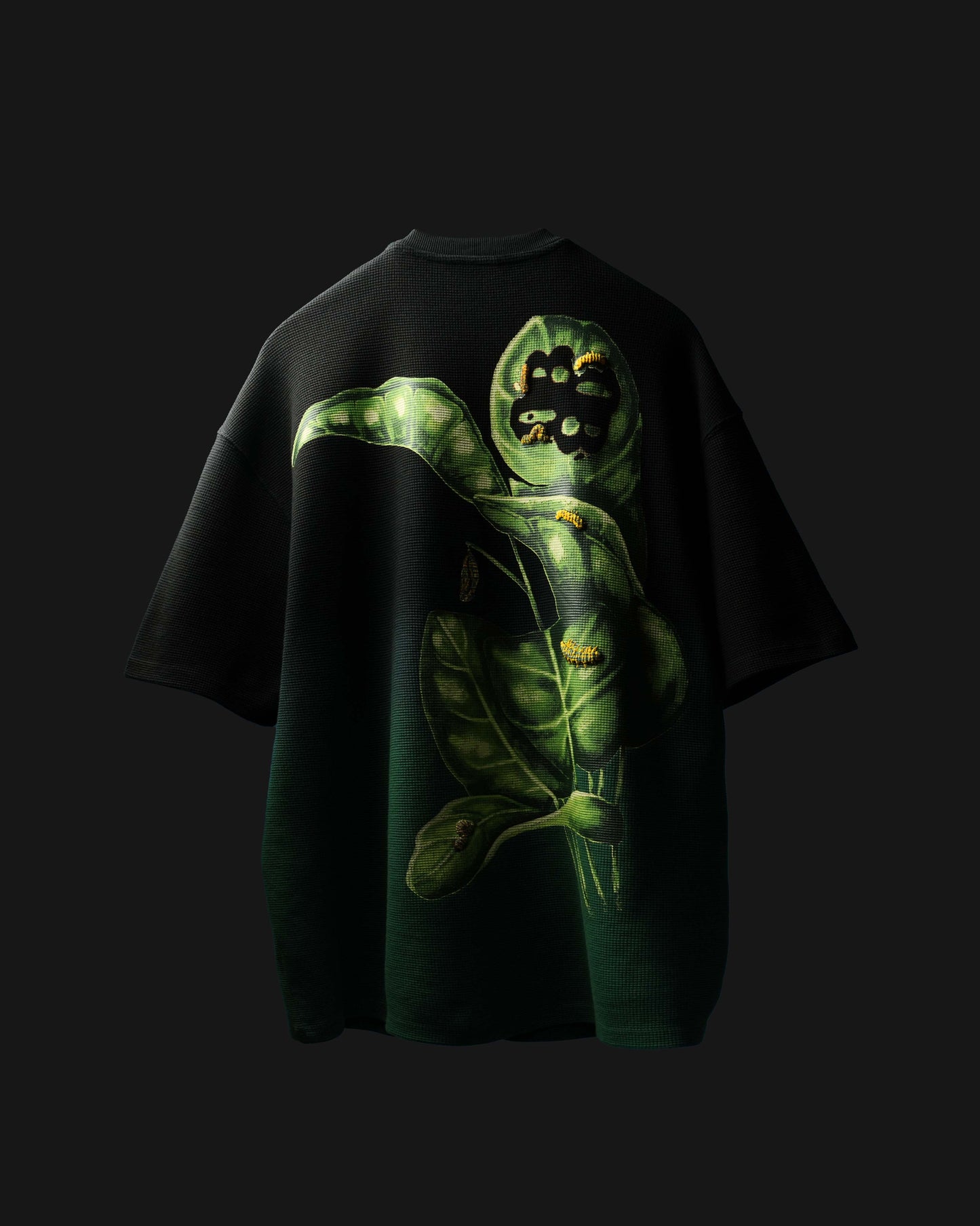 Black Fade Flora T-Shirt with green caterpillar design on a dark background