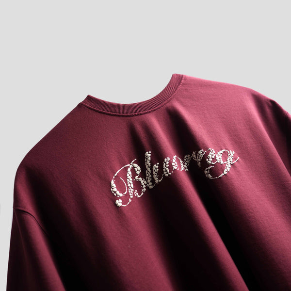 Oversized burgundy streetwear t-shirt with bold graphic